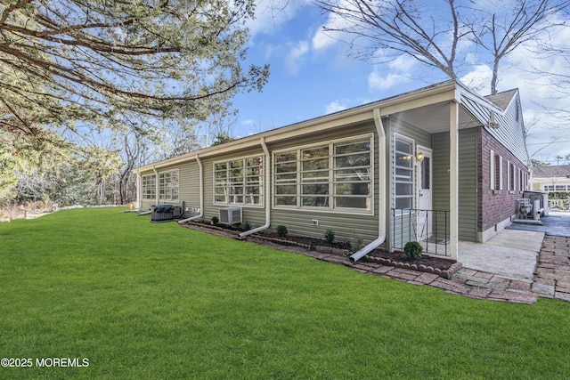 rear view of house with a lawn