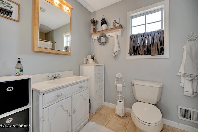 bathroom featuring vanity, tile patterned flooring, and toilet