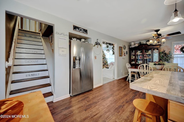 kitchen with dark hardwood / wood-style flooring, stainless steel fridge with ice dispenser, hanging light fixtures, and ceiling fan