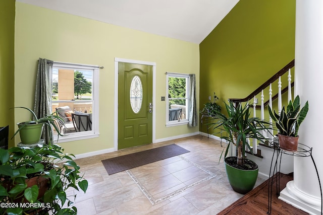 tiled entrance foyer with plenty of natural light and lofted ceiling