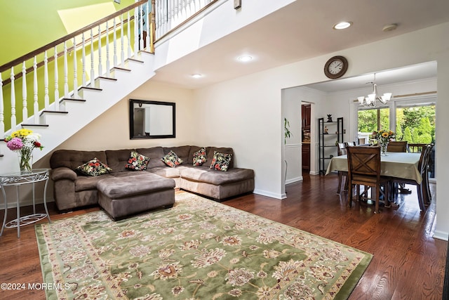 living room with dark hardwood / wood-style floors and an inviting chandelier