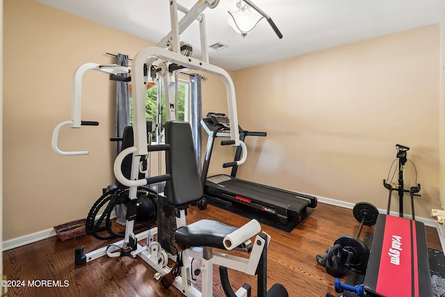 exercise room with hardwood / wood-style flooring