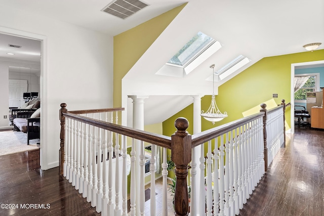 hall with dark hardwood / wood-style floors and lofted ceiling