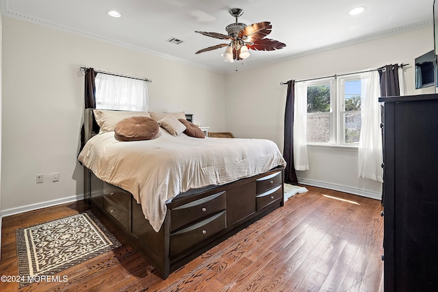 bedroom with baseboard heating, ceiling fan, crown molding, and dark hardwood / wood-style floors