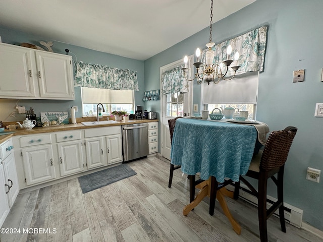 kitchen featuring white cabinetry, dishwasher, sink, pendant lighting, and light wood-type flooring