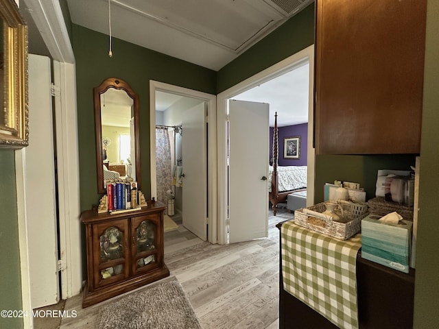 hallway with light hardwood / wood-style flooring