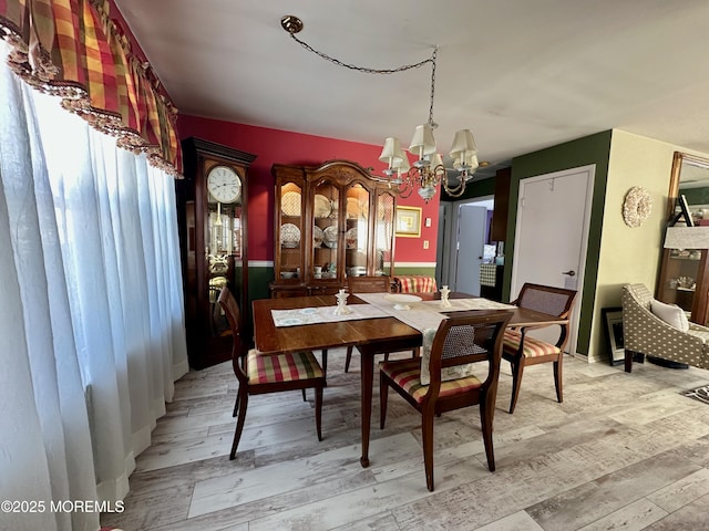 dining room featuring an inviting chandelier and light wood-type flooring