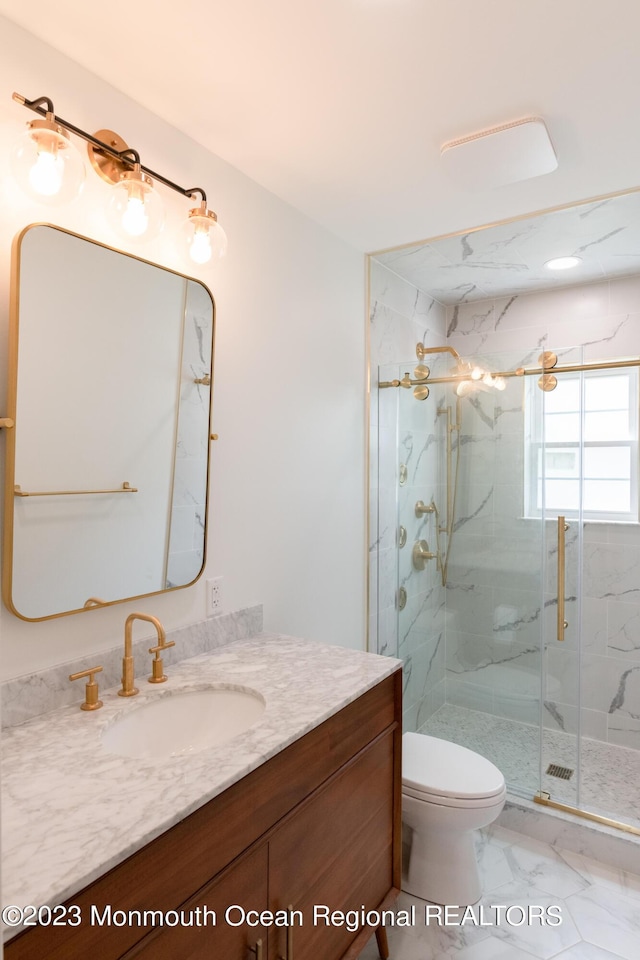 bathroom featuring vanity, toilet, and walk in shower