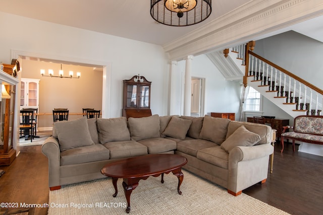 living room with crown molding, a chandelier, and hardwood / wood-style flooring