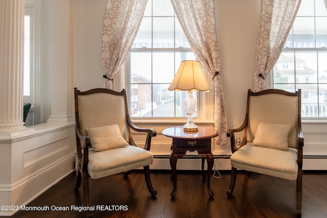 living area featuring hardwood / wood-style floors and baseboard heating