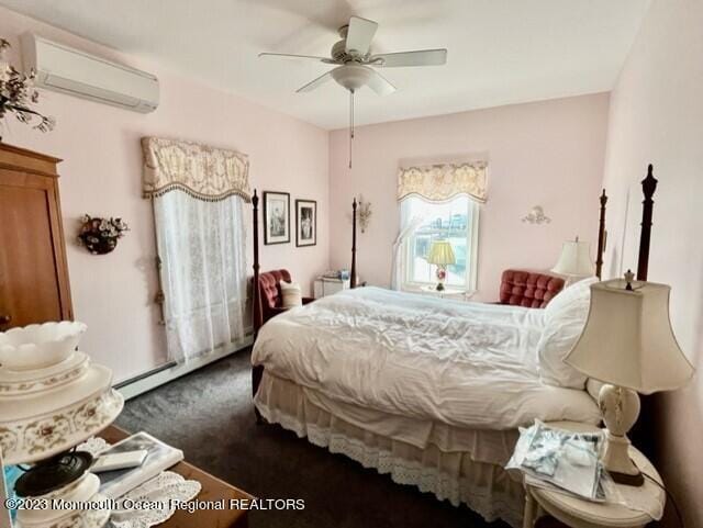 bedroom featuring an AC wall unit, ceiling fan, and a baseboard radiator