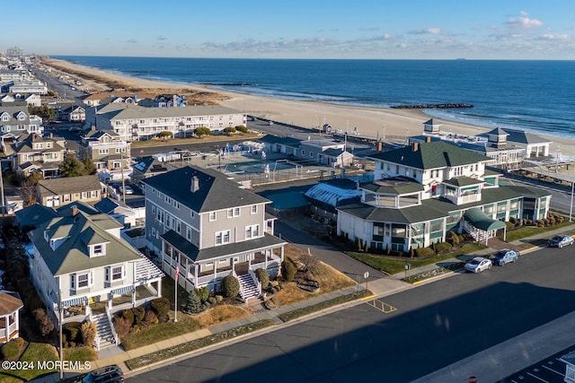 birds eye view of property with a view of the beach and a water view