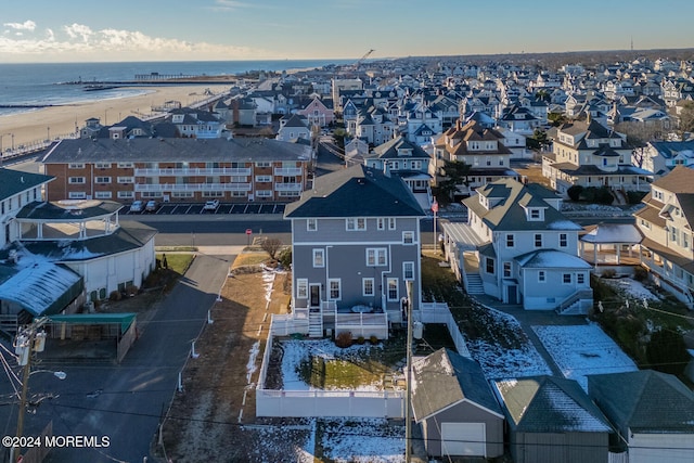 bird's eye view with a water view and a beach view