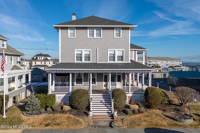 back of property featuring covered porch