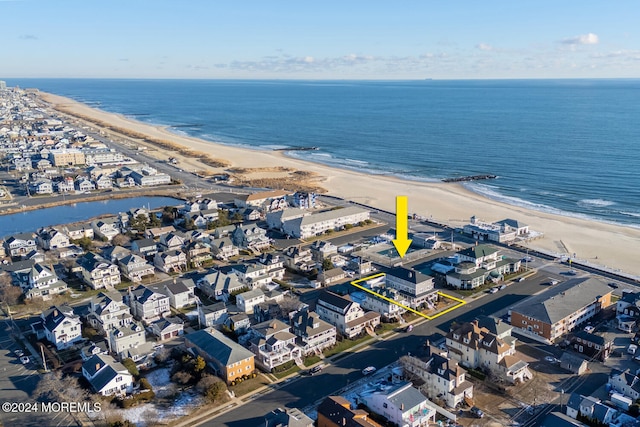 aerial view with a water view and a beach view