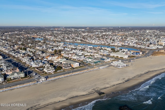 drone / aerial view with a beach view and a water view