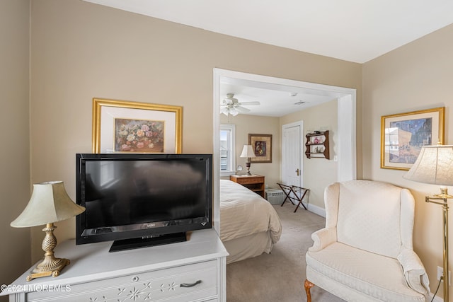 bedroom with ceiling fan and light carpet