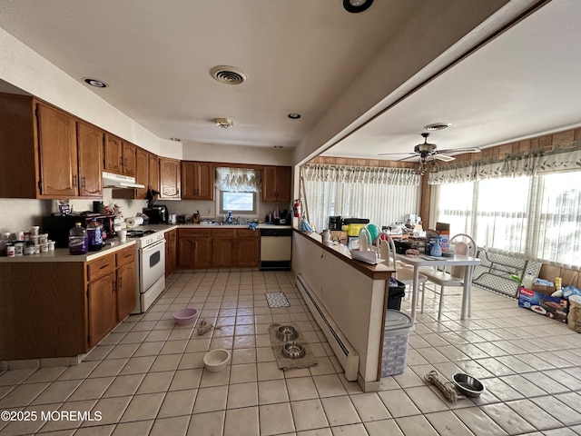 6 Westport Dr, Toms River, NJ 08757 - kitchen with dishwashing machine, white range, light tile patterned floors, and baseboard heating