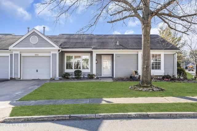 ranch-style house featuring a front yard and a garage