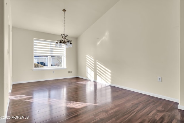 interior space with dark wood-type flooring and a chandelier