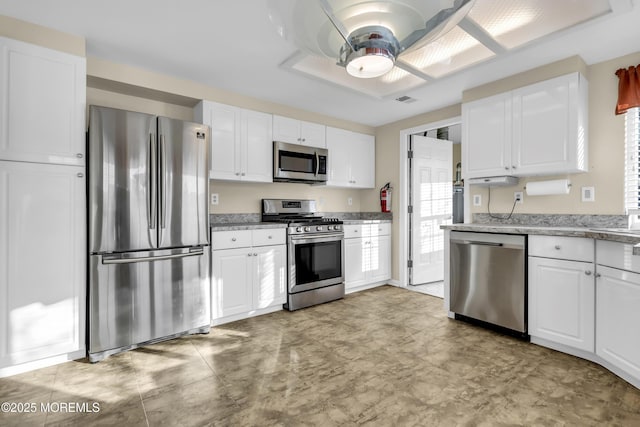 kitchen featuring stainless steel appliances and white cabinetry