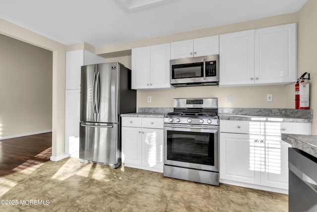 kitchen featuring white cabinets and appliances with stainless steel finishes