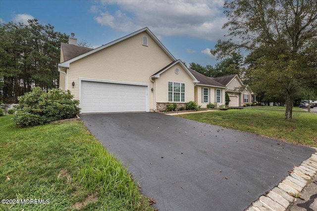 view of front of house with a garage and a front yard