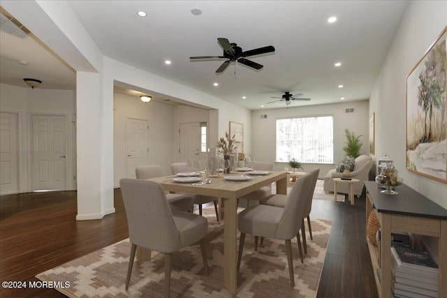 dining space featuring dark wood-type flooring and ceiling fan