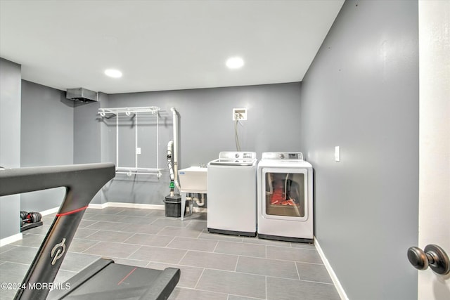 laundry room with sink, light tile patterned floors, and washer and clothes dryer