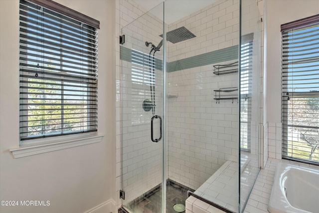 bathroom featuring shower with separate bathtub