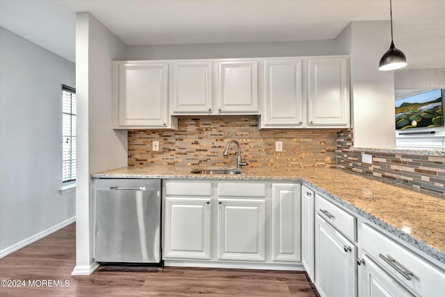 kitchen with decorative light fixtures, dishwasher, sink, and white cabinets