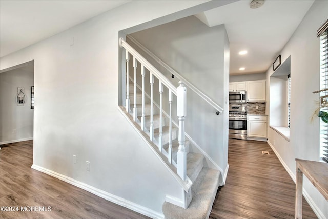 stairway featuring hardwood / wood-style flooring