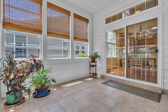 unfurnished sunroom with a notable chandelier