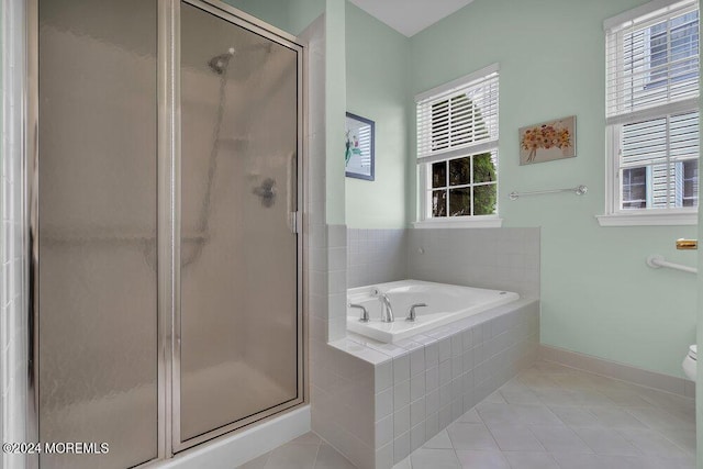 bathroom with tile patterned floors and plus walk in shower