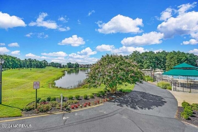 surrounding community featuring a yard and a water view