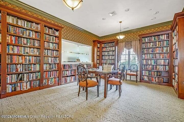 carpeted dining area with ornamental molding