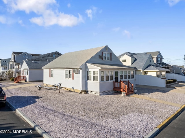 view of front of home featuring a sunroom