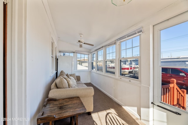 sunroom featuring ceiling fan