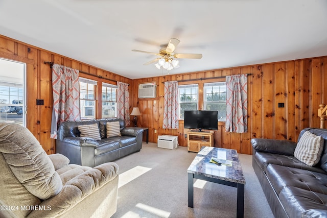 living room featuring ceiling fan, wooden walls, carpet, and a wall mounted air conditioner