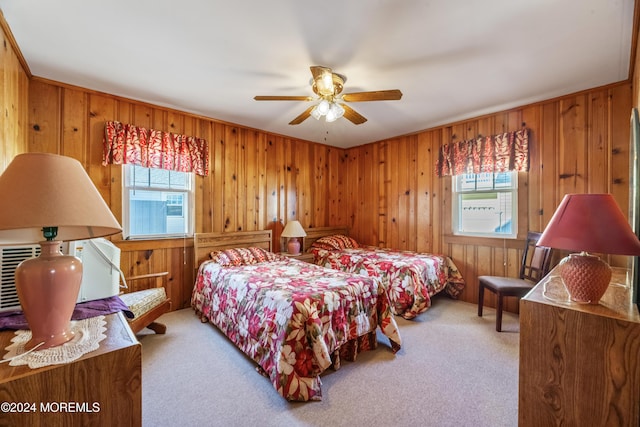 carpeted bedroom with ceiling fan and multiple windows