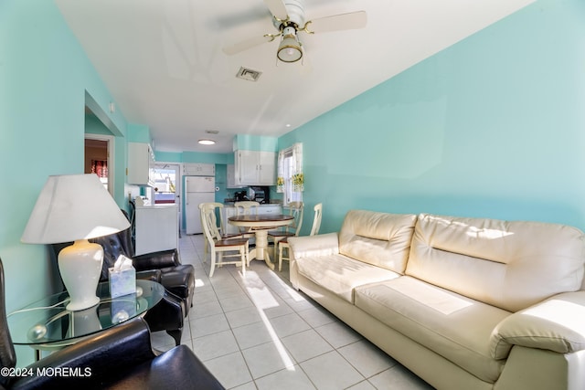 living room with ceiling fan and light tile patterned flooring