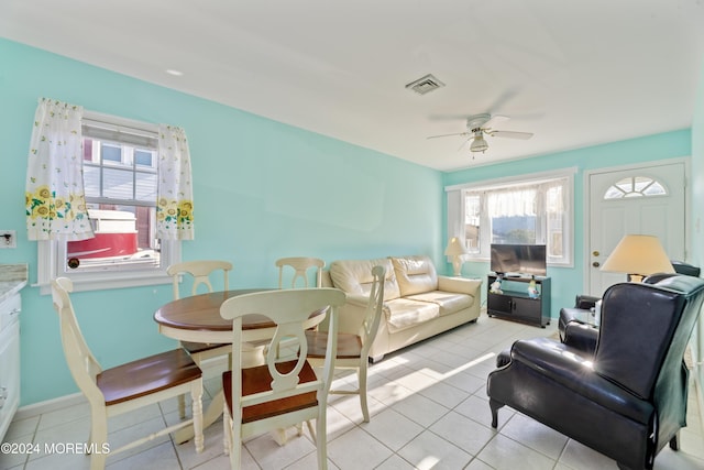 living room with ceiling fan and light tile patterned floors