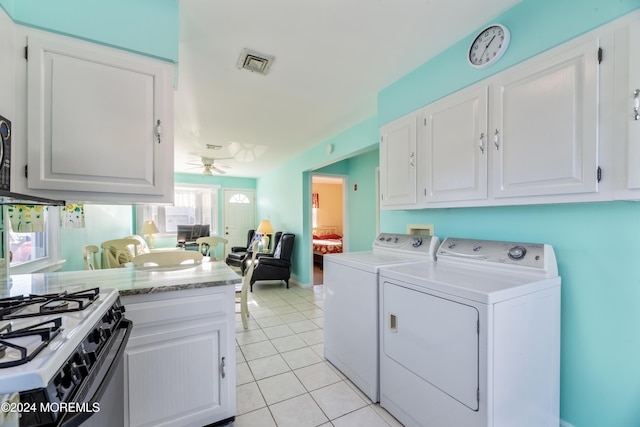 laundry area with separate washer and dryer, ceiling fan, and light tile patterned floors