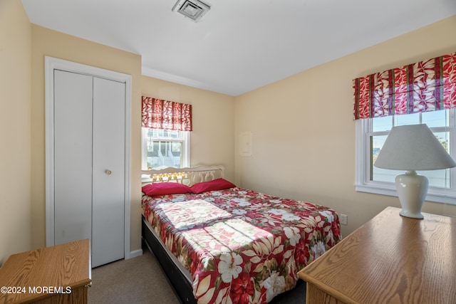 bedroom with carpet and a closet