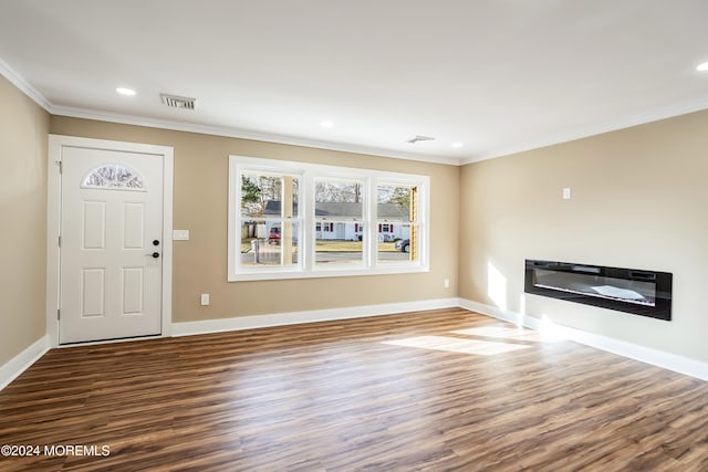 unfurnished living room featuring hardwood / wood-style flooring and crown molding