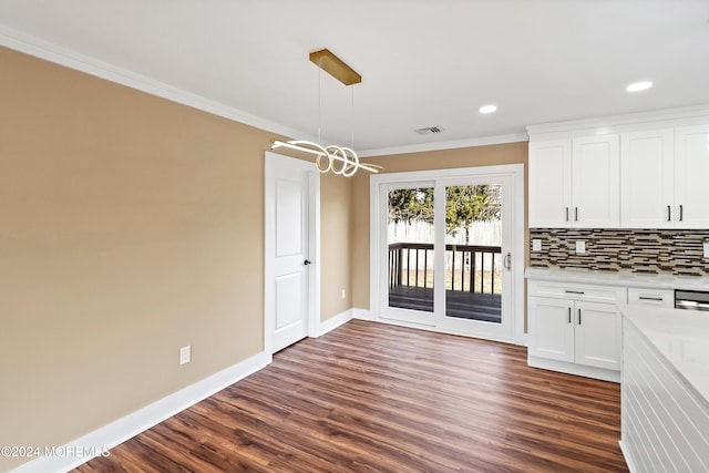 unfurnished dining area with dark hardwood / wood-style floors and ornamental molding