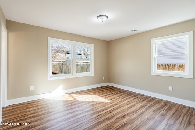 empty room with hardwood / wood-style floors