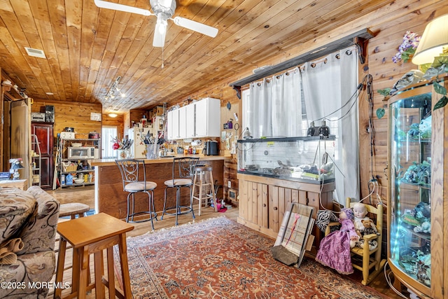 790 Farmingdale Rd, Jackson, NJ 08527 - kitchen featuring wooden ceiling, plenty of natural light, a ceiling fan, wood walls, and stainless steel microwave