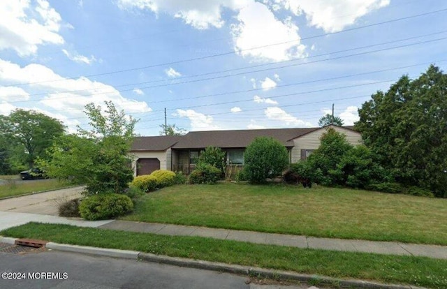 single story home with a front yard and a garage