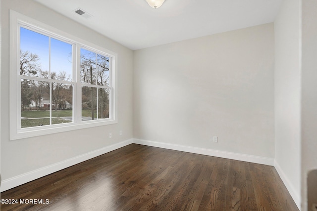 empty room with dark wood-type flooring